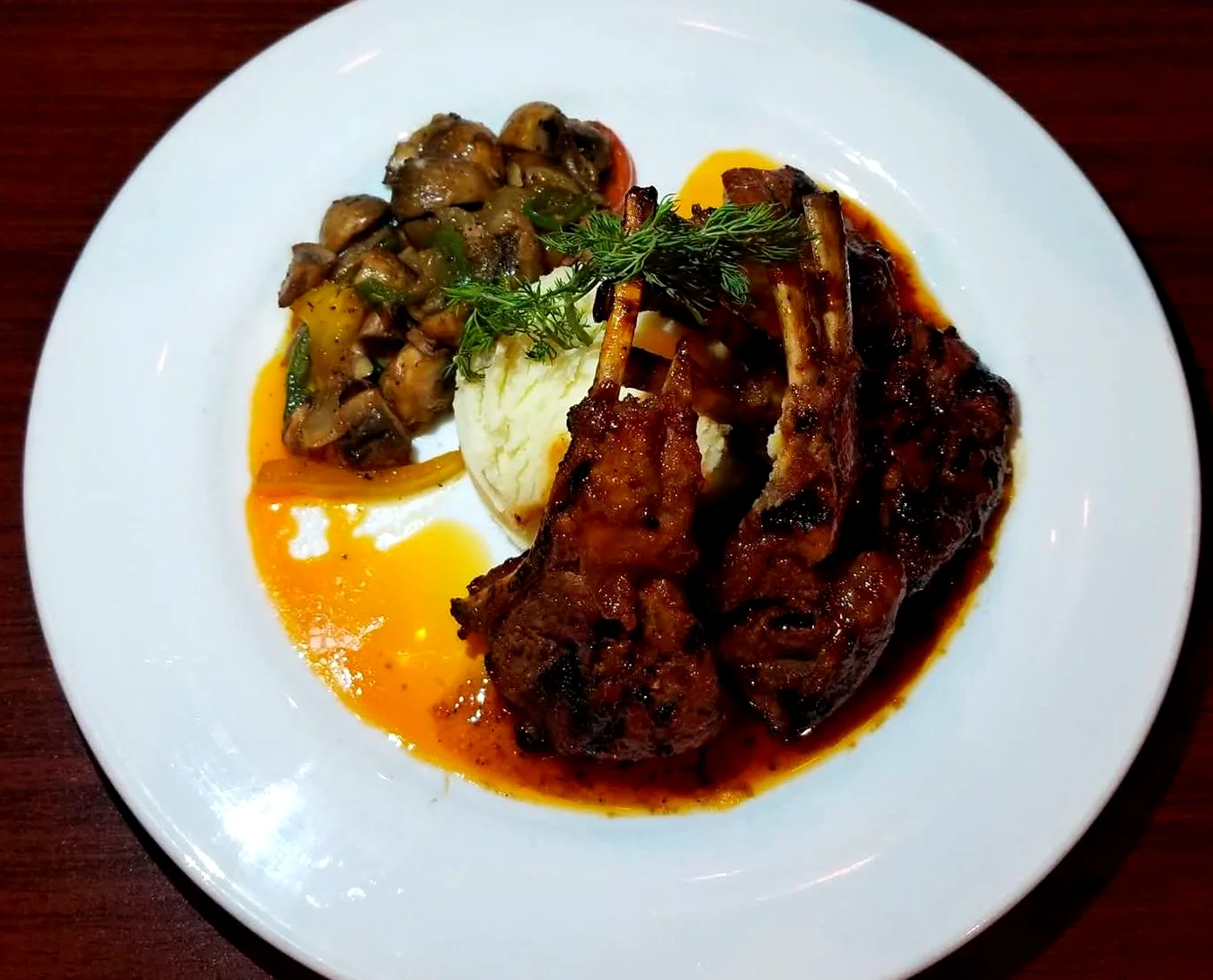 Jerk lamb chops plated with mushrooms and mash